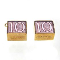 Two 9 carat gold charms, each containing a ten shilling note (2)