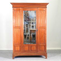 An Edwardian single wardrobe, with a mirrored door 128w x 54d x 188h cm