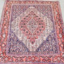 A Persian rug, with a large central diamond and all over foliate designs, 136 x 120cm