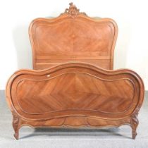 An early 20th century French walnut double bedstead, with a slatted wood base, 150cm wide