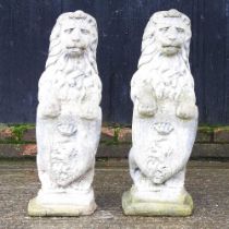 A pair of cast stone garden statues of lions, 72cm high