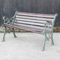 A slatted garden bench, with green painted metal ends, 127cm wide