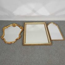 A gilt wall mirror, of cartouche shape, 82 x 60cm, together with two others (3)