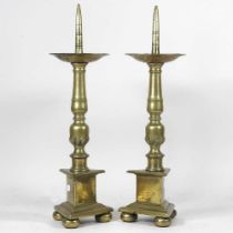 A pair of 19th century brass pricket candlesticks, each having a dished top, baluster column and