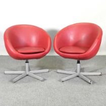 A pair of contemporary red upholstered swivel armchairs, on metal bases