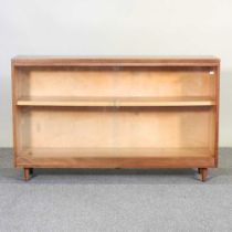 A mid 20th century teak dwarf bookcase, with sliding glass doors 122w x 31d x 76h cm