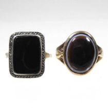 A 9 carat gold polished onyx cabochon ring, 6.2g, size N, together with a black onyx dress ring,