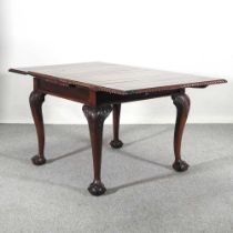 An early 20th century draw leaf dining table, on claw and ball feet 148l x 90w x 74h cm overall