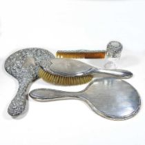 An early 20th century silver hand mirror, together with a collection of silver dressing table items,