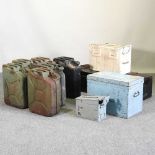 A collection of metal jerry cans, together with various ammunition boxes