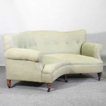 A Victorian patent green upholstered corner sofa, in the manner of Howard & son, later upholstered