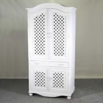An eastern white painted hardwood larder cupboard, enclosed by lattice doors 108w 70d x 219h cm