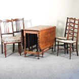 A 1920's oak gateleg dining table, 106cm, together with a pair of ladderback chairs and a pair of