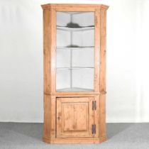 An antique pine standing corner cabinet, with a painted interior 105w x 60d x 214h cm