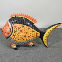 A large painted metal tea light holder, in the form of a fish, 90cm wide