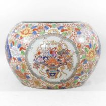 An early 20th century Japanese Imari jardiniere, reserved with flowers, 33cm diameter