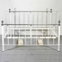 A modern cream painted metal bedstead, with a slatted wooden base 190w x 210l cm