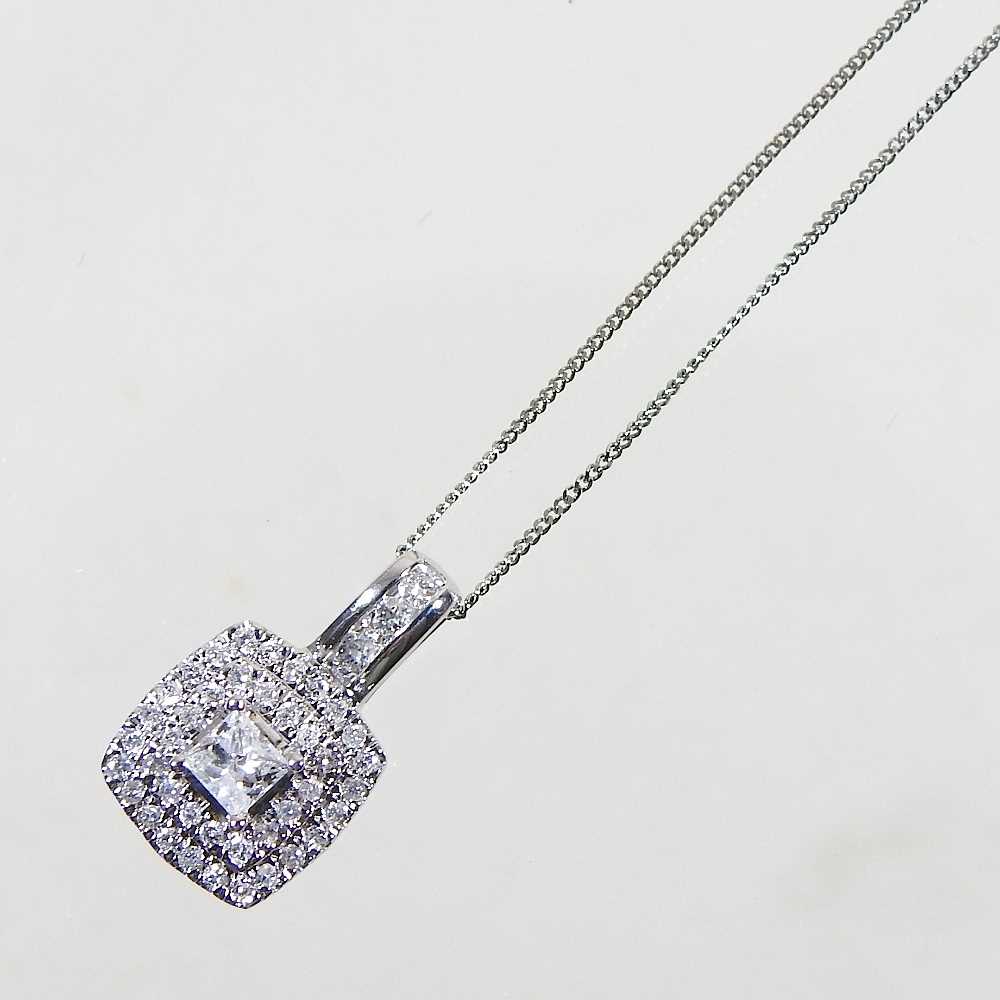 A 9 carat gold diamond cluster pendant, 9mm wide, on a fine chain, approximately 0.5 carats, 2.5g