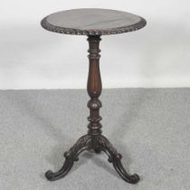 A Victorian carved oak wine table, on a tripod base 46w x 75h cm
