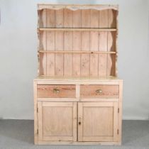 An antique pine dresser, with a boarded back 122w x 61d x 199h cm