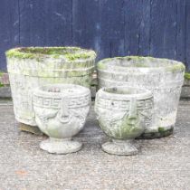 A pair of cast stone barrel garden pots, 40cm diameter, together with a pair smaller (4)