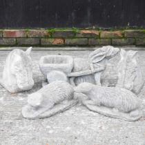 A pair of cast stone horse head finials, 33cm high, together with a pair of otters and a donkey