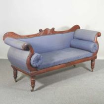 A William IV carved mahogany scroll end sofa, upholstered in blue, with scrolled arms, on turned