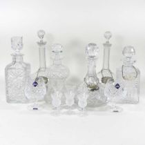 A collection of four silver decanter labels, together with crystal decanters and glassware, to