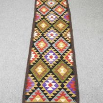 A kilim runner, with rows of coloured diamonds, 215 x 67cm