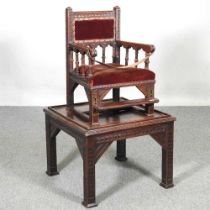 A Victorian gothic child's metamorphic high chair/table, with an upholstered seat 53w x 52d x 92h cm