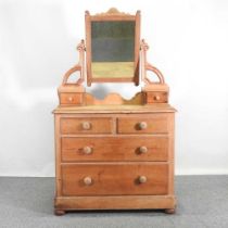 An antique pine dressing chest with a mirrored top 105w x 54d x 174h cm