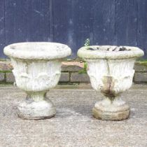 A pair of cast stone garden urns, 36cm high (2)