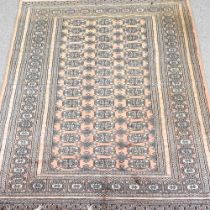 A modern Bokhara rug, with three rows of medallions, on a red ground, 185 x 216cm