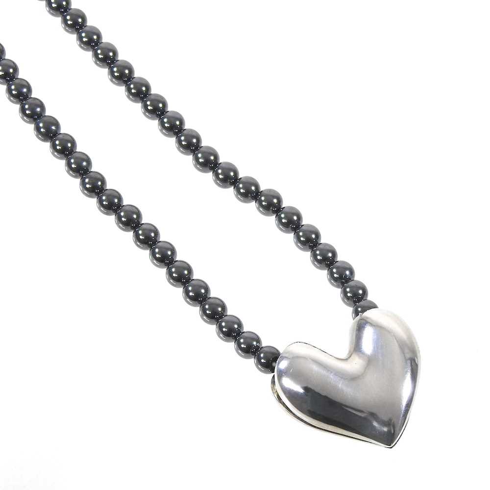 A Danish hematite bead necklace, with a removable silver heart pendant, designed by Allan Schaff for