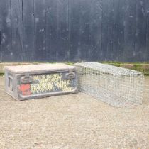 An iron box, 62cm wide, together with an animal trap (2)