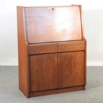 A 1960's teak bureau, with a hinged sloping fall 76w x 41d x 107h cm