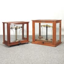 A set of scientific scales, cased, 45cm, together with a smaller set (2)