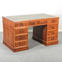 A reproduction yew wood pedestal desk 137w x 76d x 77h cm