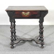 An 18th century oak side table, with later elements, containing a single drawer, on turned legs