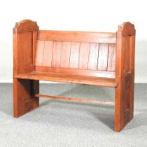 A 19th century pine church pew, with a boarded back and panelled ends 109w x 45d x 96h cm