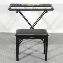 A Yamaha electric keyboard, 94cm wide, on stand with a music stool Does not have a power lead.
