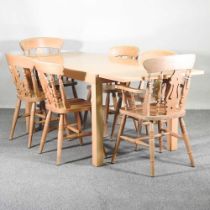 A modern extending dining table, together with a set of six beech dining chairs, to include a pair