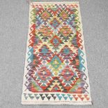 A kilim runner, with all over coloured diamonds, 143 x 64cm