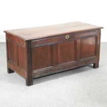 An 18th century oak coffer, of panelled construction, with a hinged lid 123w x 56d x 58h cm