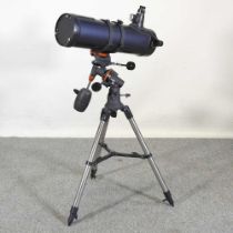 A Celestron Astromaster 130 telescope, on stand