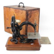 A 19th century Willcox & Gibbs sewing machine, in a pine case 38w x 25d x 33h cm