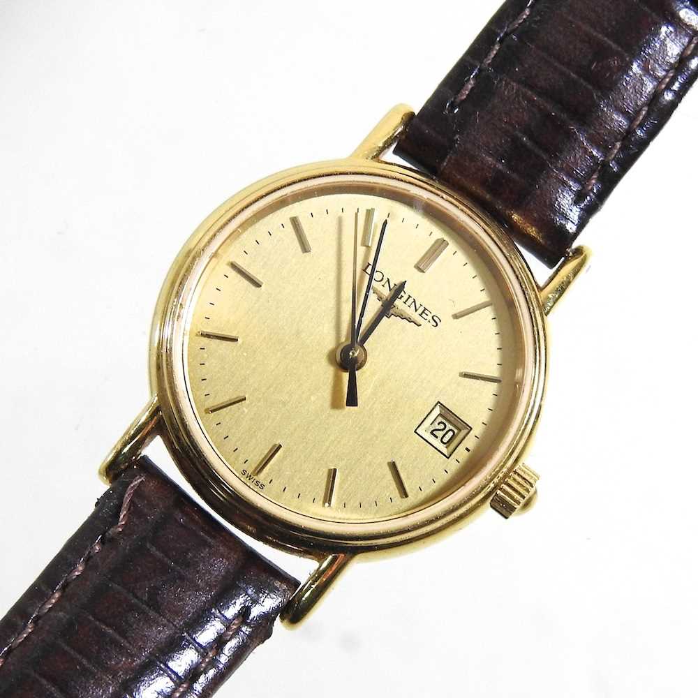 A Longines ladies gold plated wristwatch, the signed 20mm dial with baton hours and date aperture,