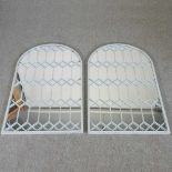 A pair of large painted metal framed wall mirrors, each of arched shape with lattice decoration, 127