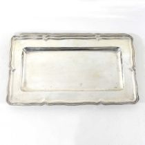 An early 20th century continental silver tray, of dished rectangular shape, with a shaped border,