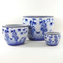 A graduated set of three modern Chinese blue and white porcelain fish bowls, decorated with